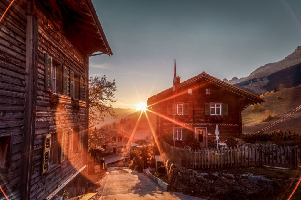 Idyllic sunset at Brigels, a mountain village in Switzerland, depicting vibrant autumn colors and the tranquility of nature, captured in autumn 2018.