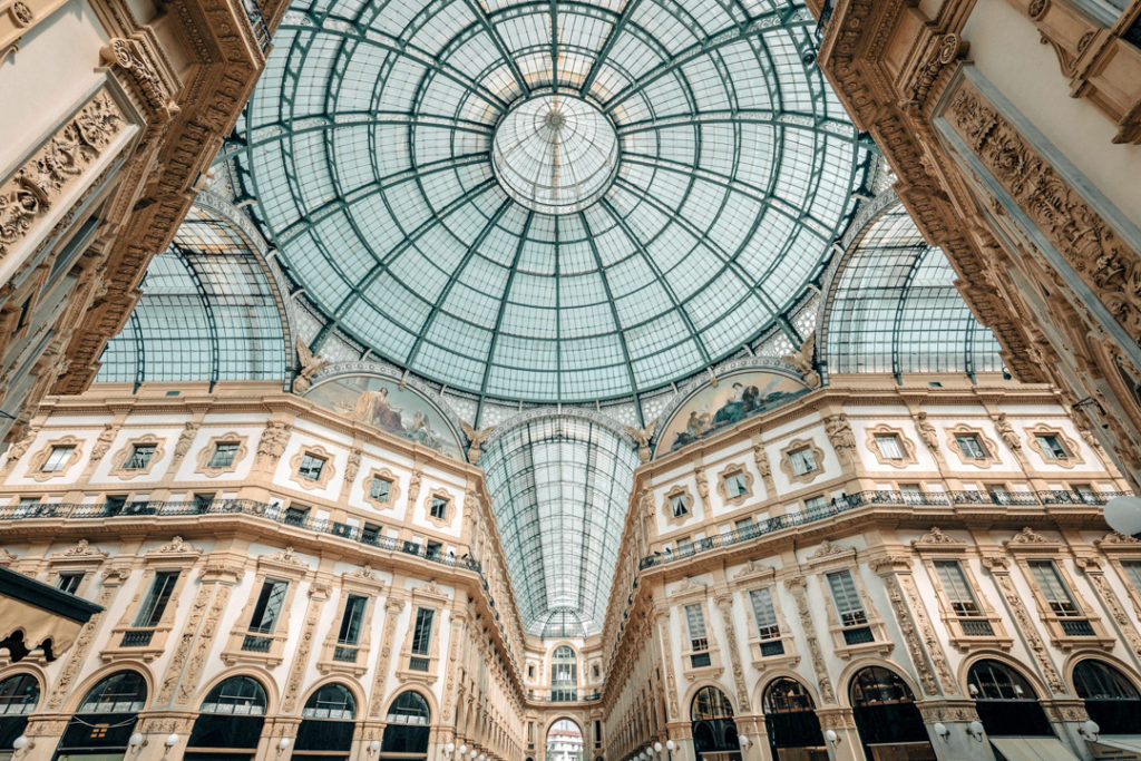 Wide-angle view of the majestic dome and architectural structure of Galleria Vittorio Emanuele II in Milan, Italy, Summer 2019.