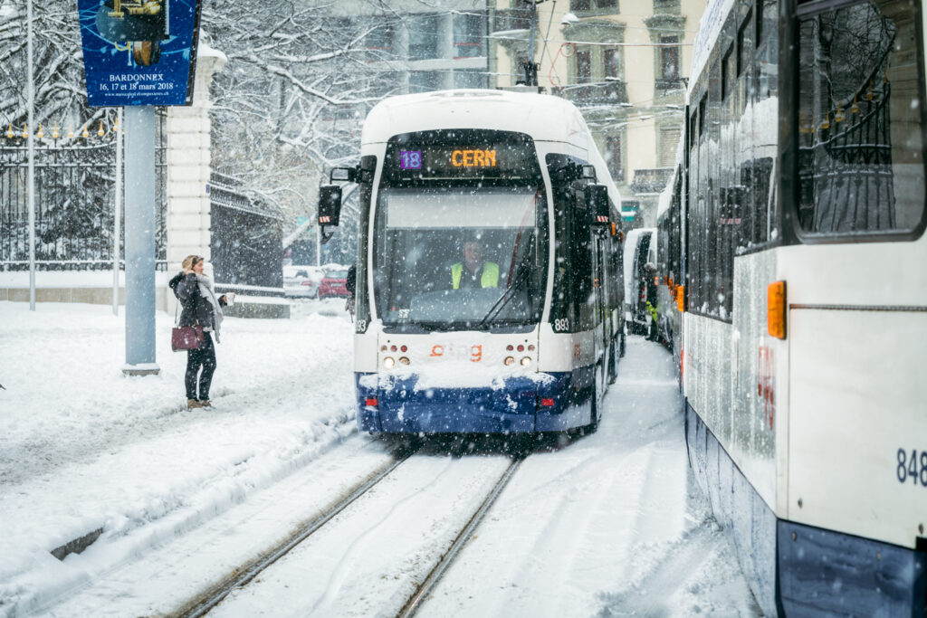 Tram under the snow at Place de Neuve, Geneva